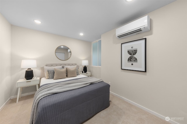 bedroom with light colored carpet and a wall unit AC