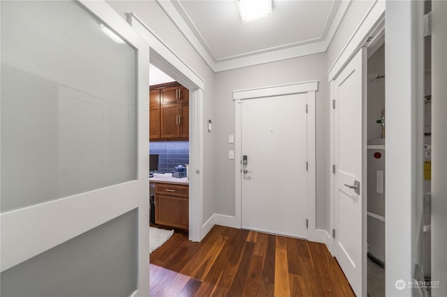 foyer entrance with dark hardwood / wood-style flooring and ornamental molding