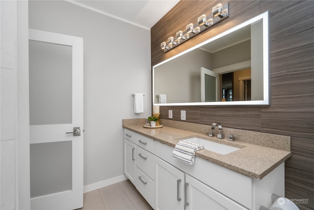 bathroom featuring crown molding, tile floors, and vanity