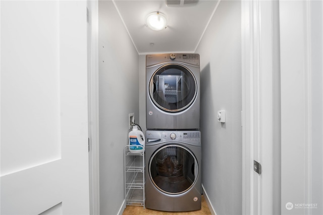 clothes washing area featuring washer hookup and stacked washer / dryer