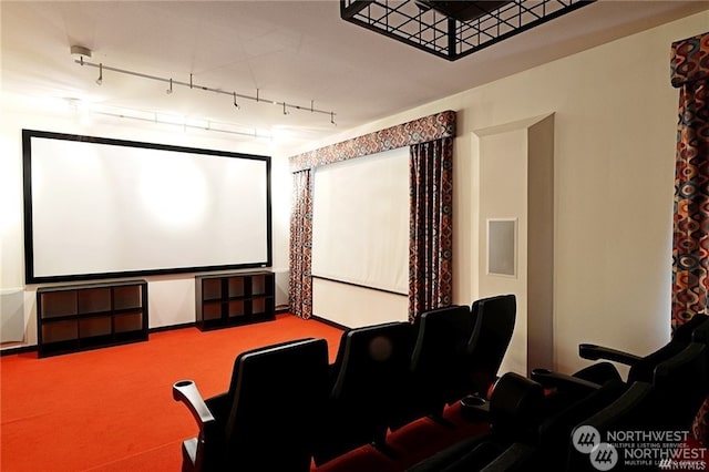 carpeted cinema room featuring rail lighting