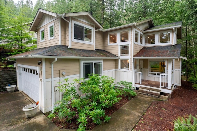 view of front of home with a garage and a porch