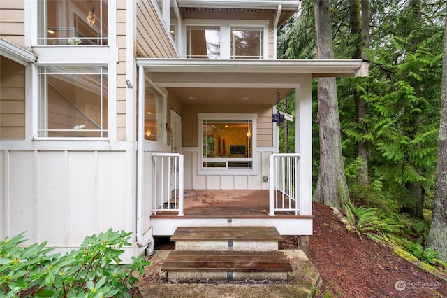 view of exterior entry with board and batten siding