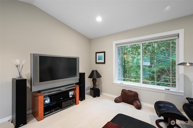 carpeted living room with vaulted ceiling