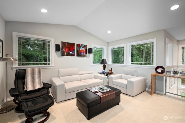 living room with a healthy amount of sunlight, light carpet, and vaulted ceiling