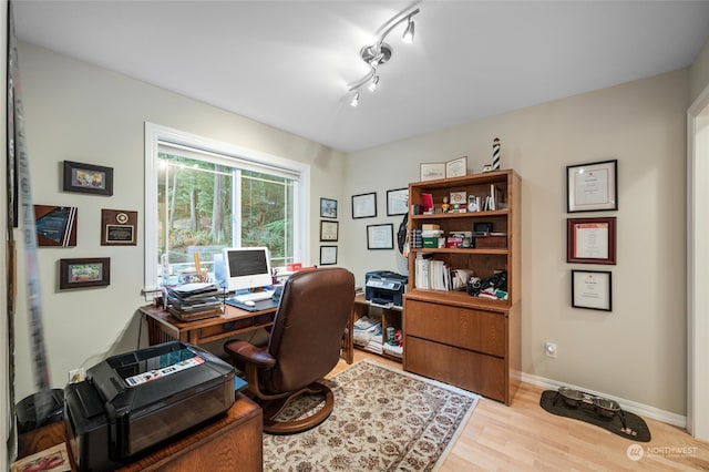 home office featuring track lighting and light hardwood / wood-style flooring