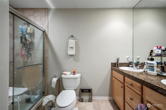 bathroom featuring vanity, tile patterned flooring, and toilet