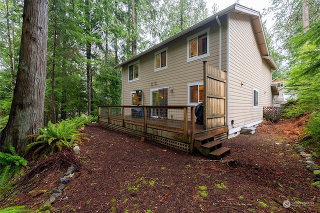 back of house featuring a wooden deck