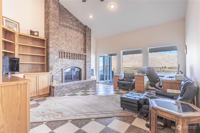 living room featuring a fireplace, a mountain view, high vaulted ceiling, and a wealth of natural light