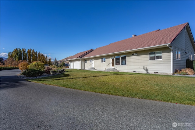 single story home with a front lawn and a garage