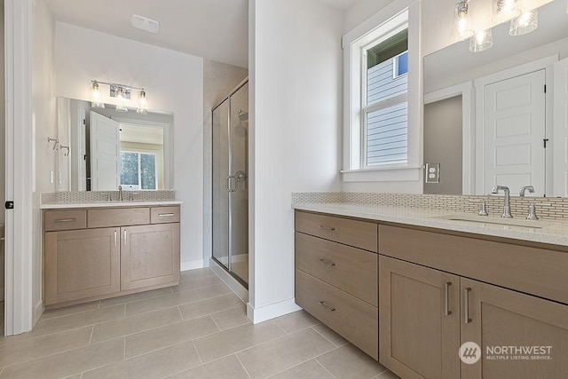 bathroom featuring tile patterned floors, vanity, and a shower with door