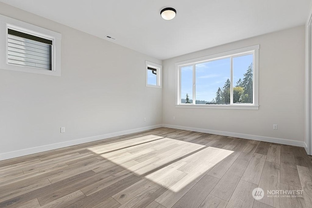 spare room featuring light wood-type flooring