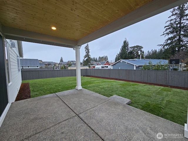 view of patio featuring a fenced backyard and a residential view