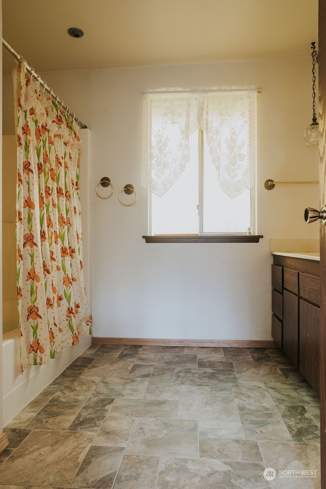 bathroom with shower / bath combo with shower curtain, tile flooring, and vanity