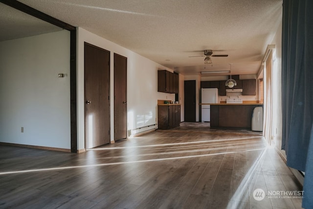 unfurnished living room featuring a textured ceiling, dark wood-type flooring, and ceiling fan with notable chandelier