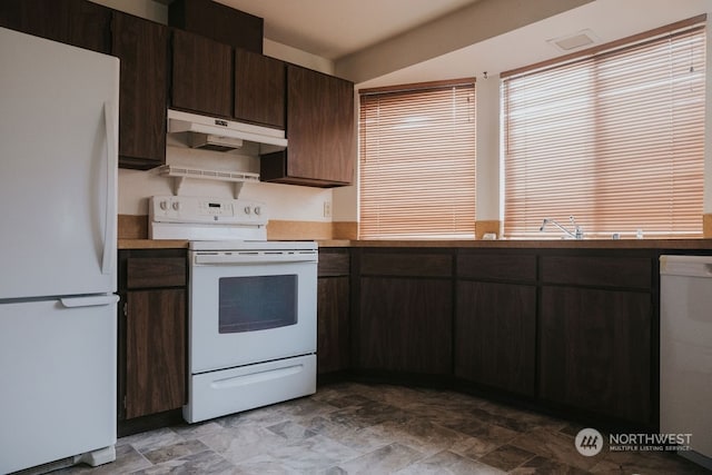 kitchen with light tile floors, dark brown cabinets, and white appliances