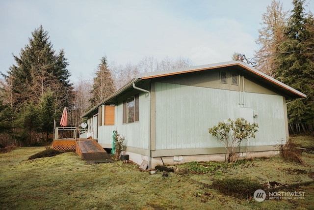 view of side of property with a yard