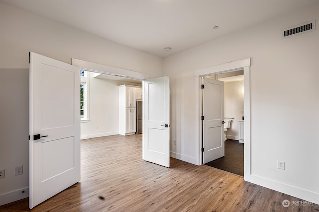 unfurnished bedroom with hardwood / wood-style flooring