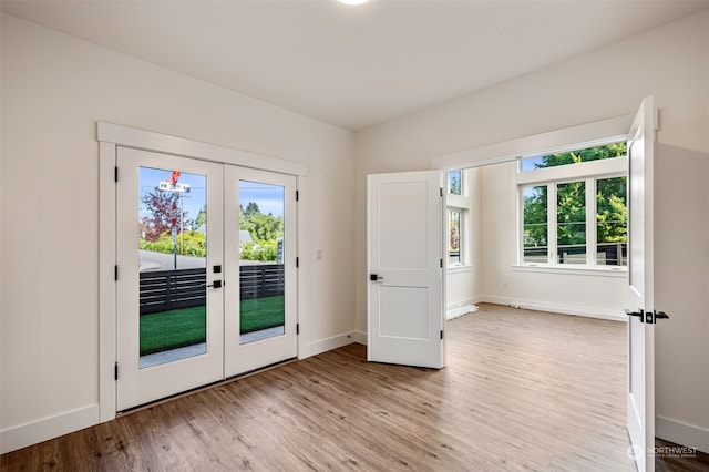 entryway featuring french doors and light wood-type flooring