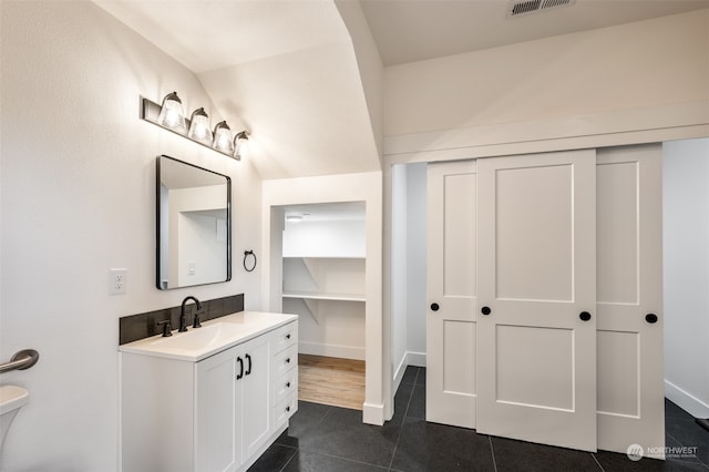 bathroom featuring wood-type flooring, toilet, and vanity