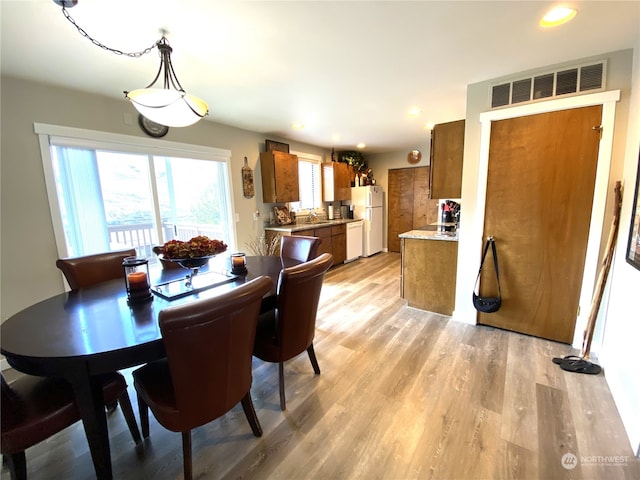 dining room featuring light hardwood / wood-style flooring and sink