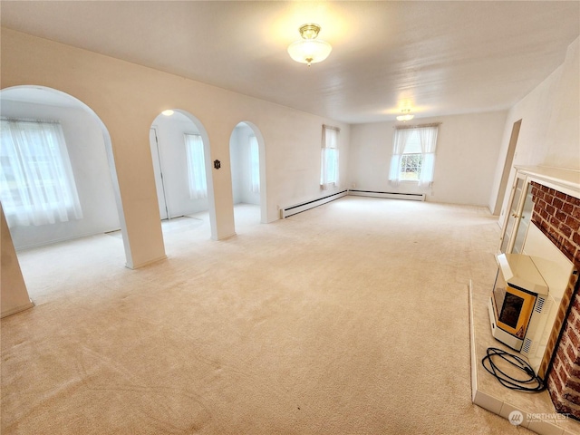 unfurnished living room featuring a baseboard radiator and light colored carpet