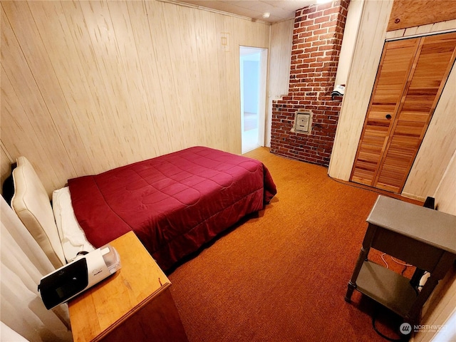 carpeted bedroom with brick wall, wooden walls, and a closet