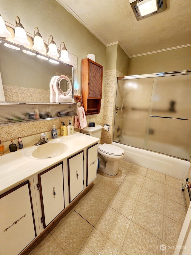 full bathroom with vanity, crown molding, shower / bath combination with glass door, and toilet