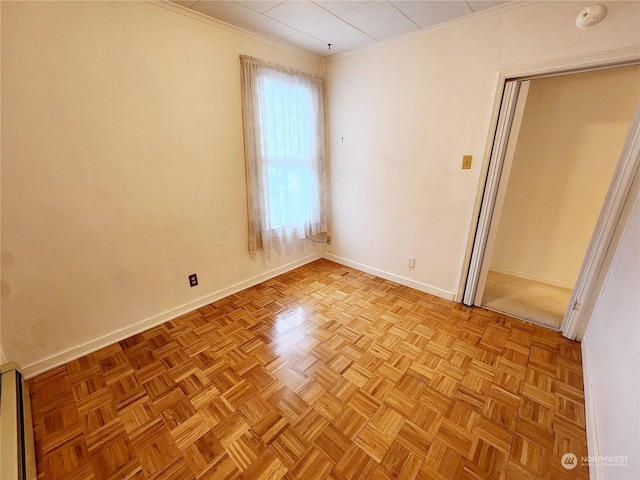 unfurnished room featuring ornamental molding and light parquet floors