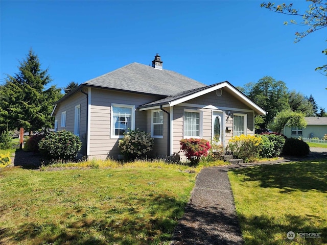 bungalow-style home featuring a front yard