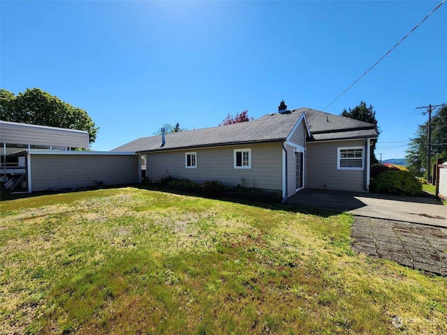 rear view of property with a lawn