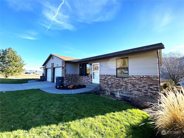 single story home featuring concrete driveway, brick siding, an attached garage, and a front lawn