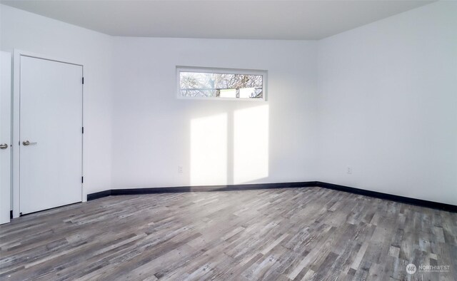 unfurnished room featuring hardwood / wood-style flooring