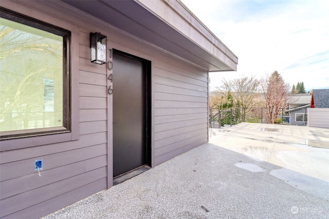 view of exterior entry with a patio area