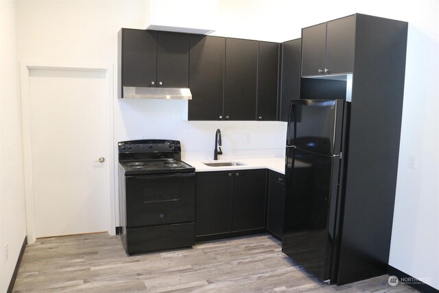 kitchen featuring sink, black appliances, and light hardwood / wood-style floors