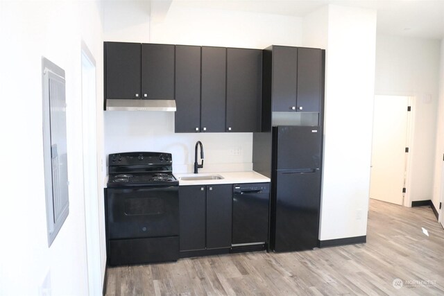 kitchen with light hardwood / wood-style floors, sink, and black appliances