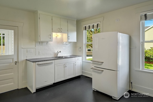 kitchen featuring decorative backsplash, white appliances, white cabinetry, and sink