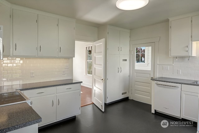 kitchen with decorative backsplash, white cabinetry, white dishwasher, and range