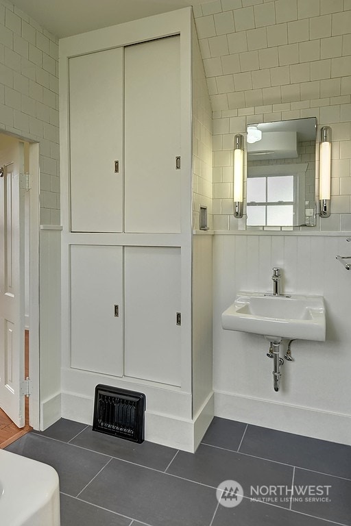 bathroom featuring sink, tile walls, and tile patterned flooring