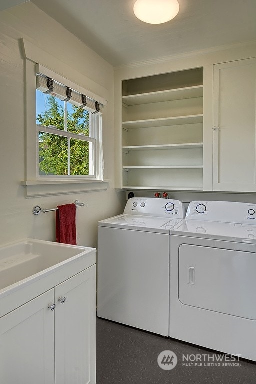 laundry room with cabinets and washer and dryer