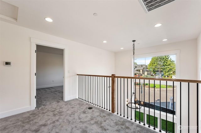 hall featuring light colored carpet