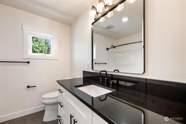 bathroom with tile patterned flooring, vanity, a shower, and toilet