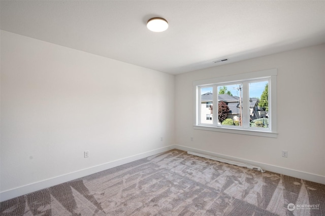 unfurnished room with light carpet