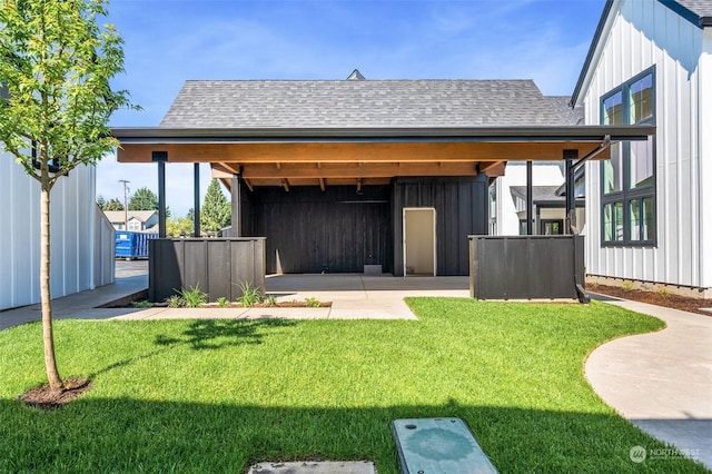 rear view of house featuring a yard