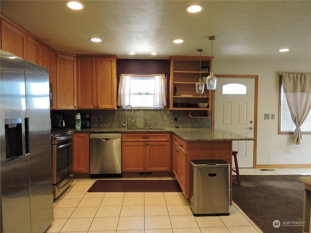 1402 Adams Rd N, Quincy, WA 98848 - kitchen with tasteful backsplash, a peninsula, light tile patterned floors, appliances with stainless steel finishes, and a sink