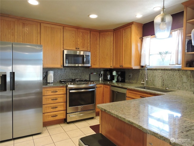 1402 Adams Rd N, Quincy, WA 98848 - kitchen featuring light tile patterned floors, light stone countertops, appliances with stainless steel finishes, a sink, and decorative backsplash