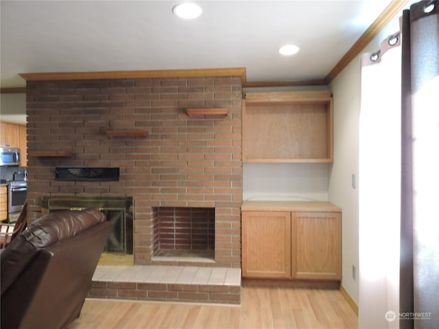 1402 Adams Rd N, Quincy, WA 98848 - living area with baseboards, recessed lighting, light wood-style flooring, crown molding, and a brick fireplace