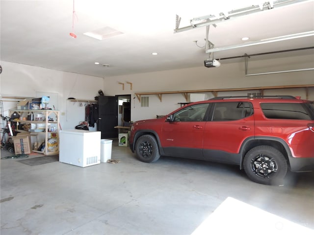 1402 Adams Rd N, Quincy, WA 98848 - garage with a garage door opener and refrigerator
