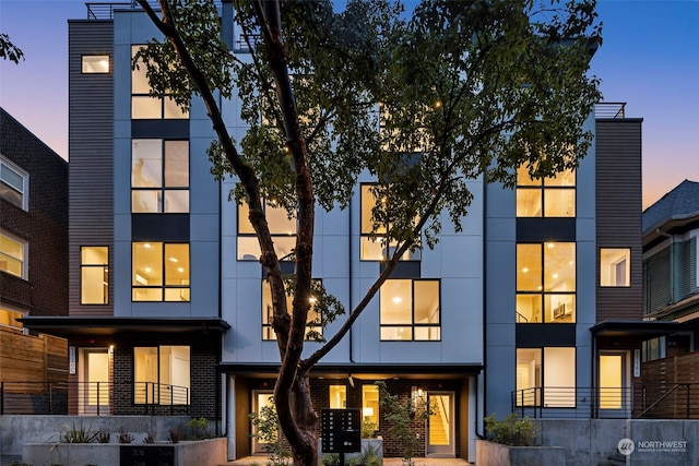 view of back house at dusk