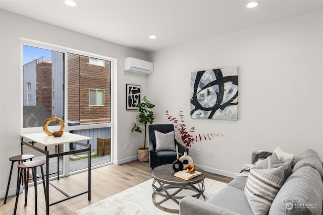 living room with light wood-type flooring and an AC wall unit